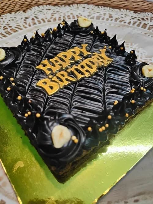 Dark chocolate custom birthday cake with gold lettering